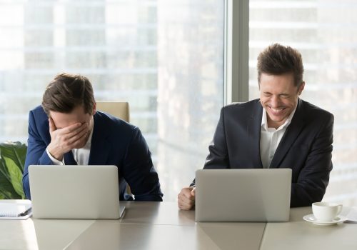 Two,Businessmen,Laughing,Out,Loud,At,Workplace,,Office,Workers,Screaming